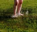 children feet on meadow